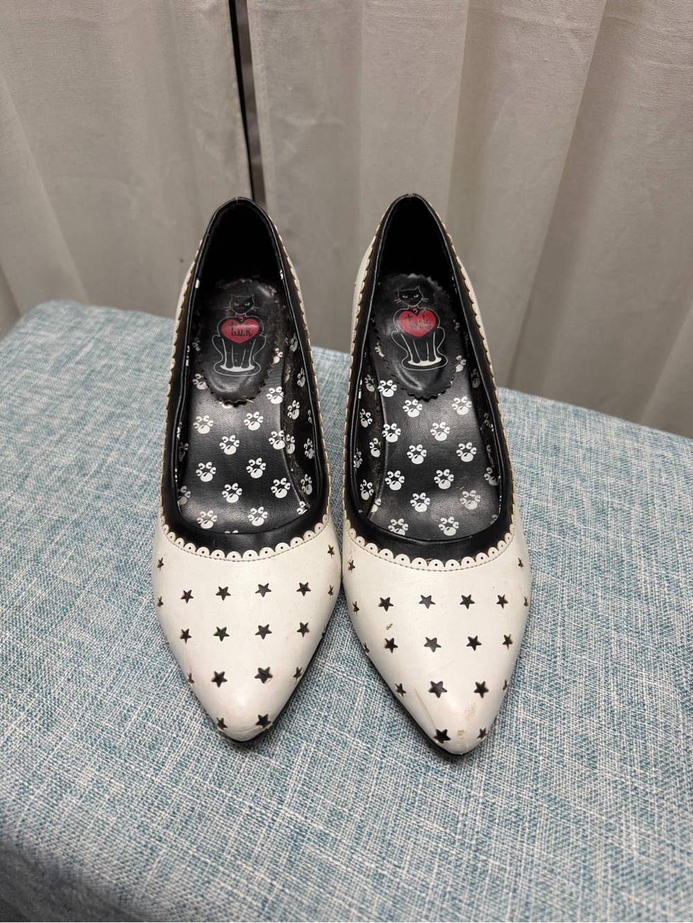 tuk White Pointed Toe Pumps with Black Star Cutouts
